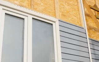 exterior of a home showing the installation of grey siding