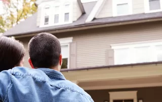 couple hugging and admiring their new home