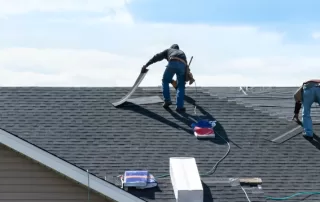 group of workers replacing a damaged shingle roof