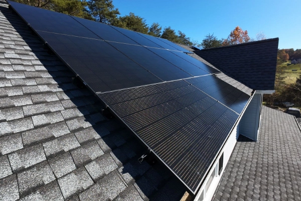 Solar panels on a home against a blue sky.