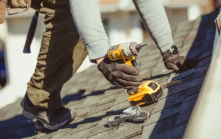 A local professional roofer works on a residential roof.